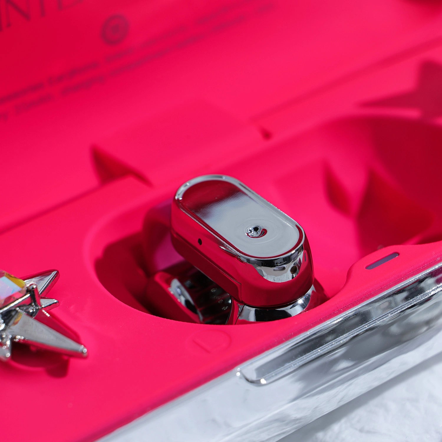 Close-up of Interstella Crystal Aura Bluetooth ear jewelry showing interchangeable crystal accessories and magnetic attachment