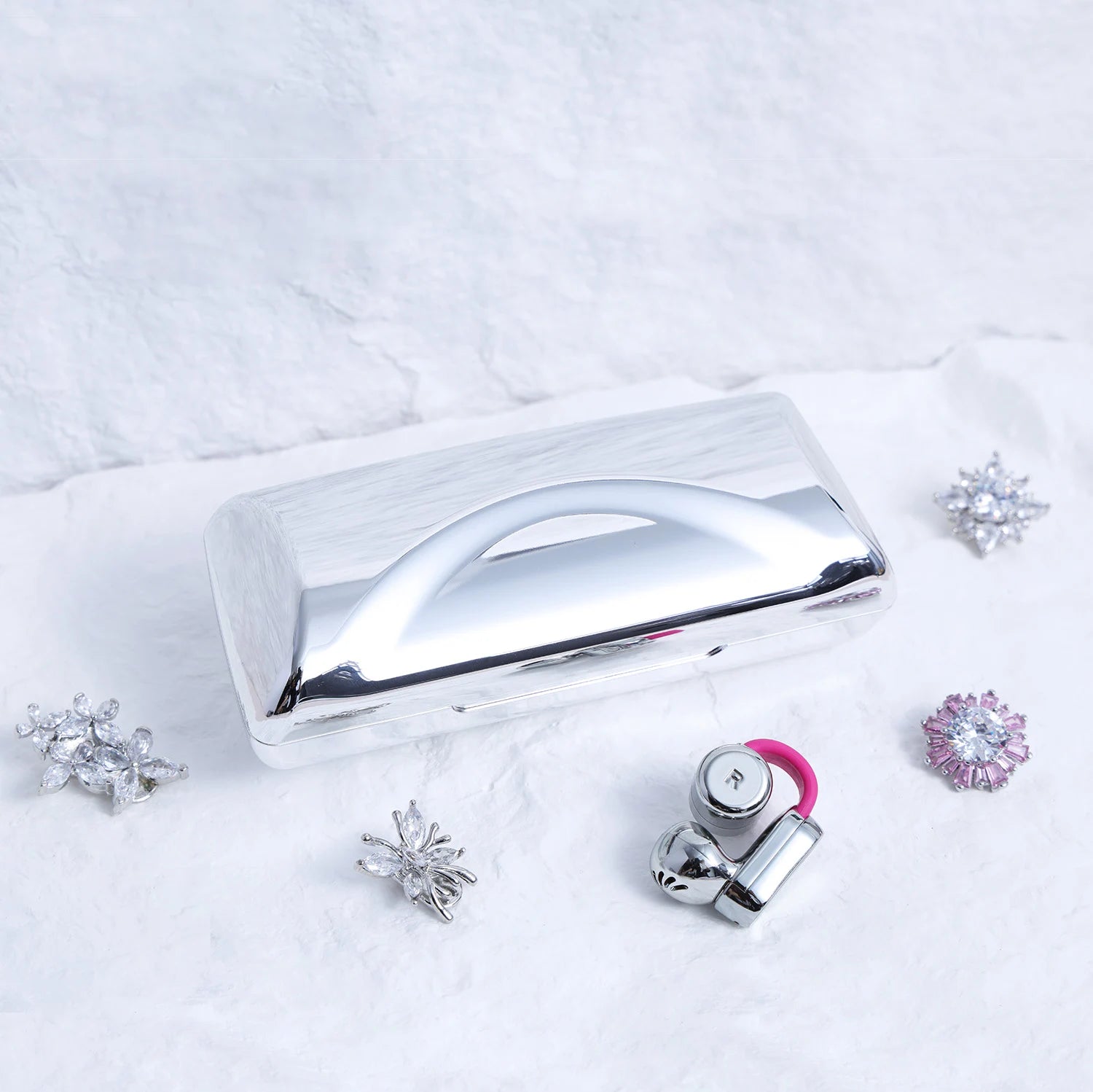 Close-up of Interstella Crystal Aura Bluetooth ear jewelry showing interchangeable crystal accessories and magnetic attachment