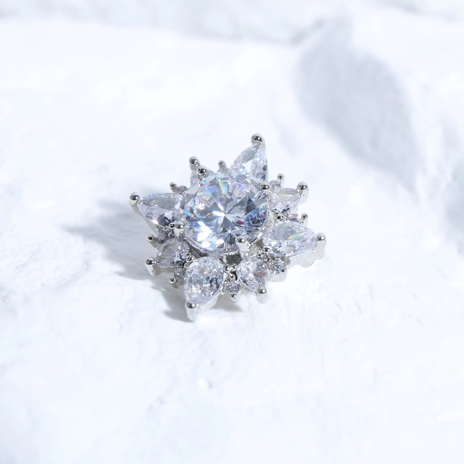 Close-up of Interstella Crystal Aura Bluetooth ear jewelry showing interchangeable crystal accessories and magnetic attachment