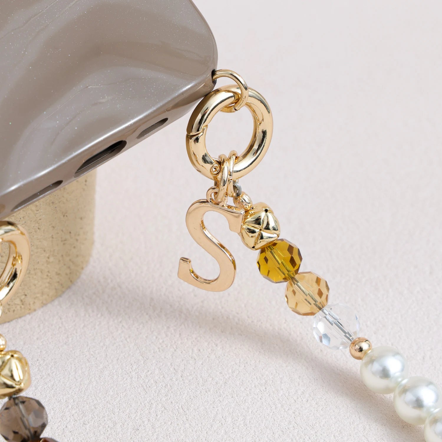 Handcrafted crystal and freshwater pearl phone strap with mixed metal accents and decorative clasp