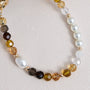 Handcrafted crystal and freshwater pearl phone strap with mixed metal accents and decorative clasp