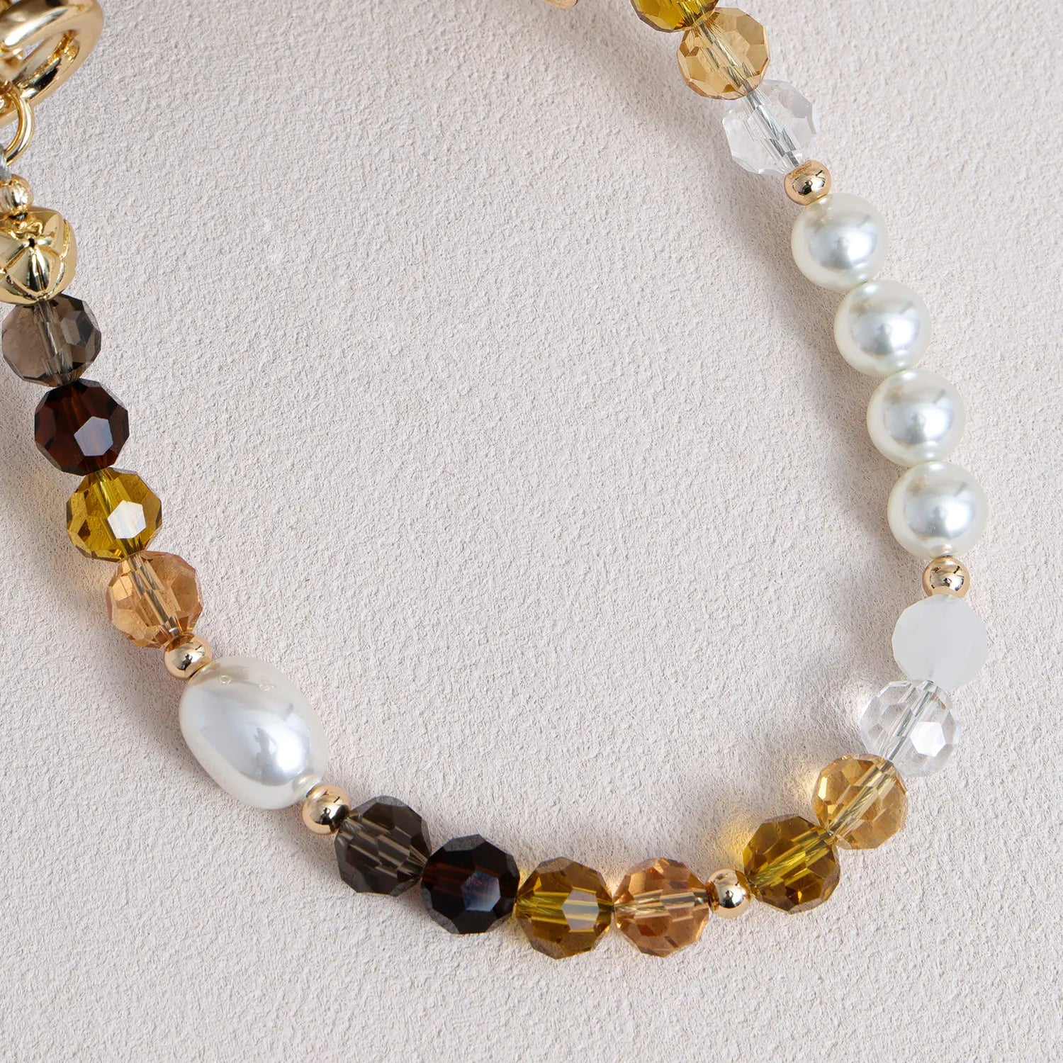 Handcrafted crystal and freshwater pearl phone strap with mixed metal accents and decorative clasp