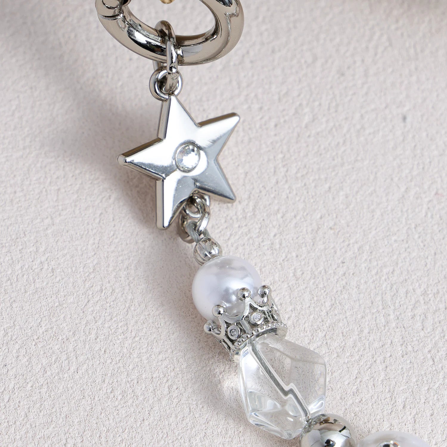 Star-shaped metal and pearl embellished phone strap with mixed metallic bead detailing
