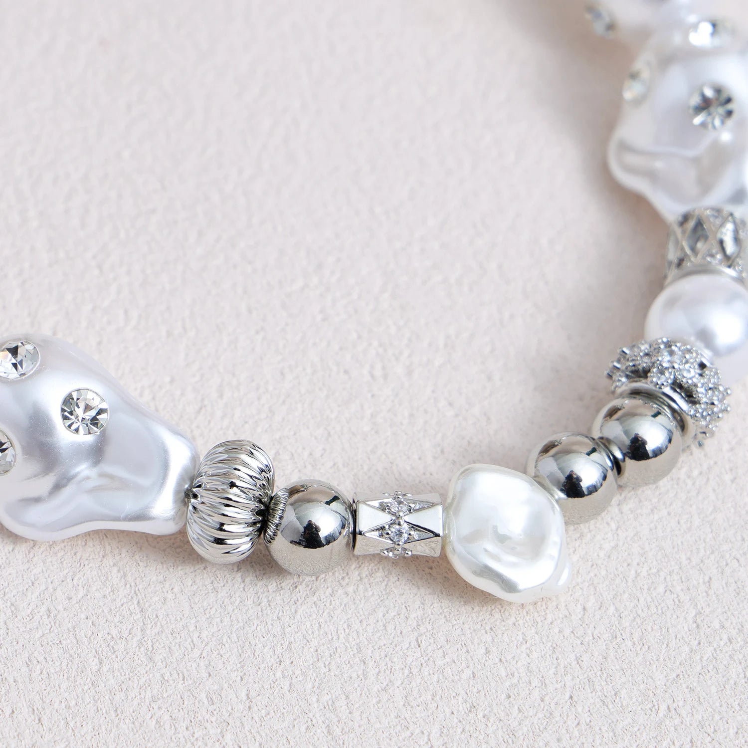 Star-shaped metal and pearl embellished phone strap with mixed metallic bead detailing