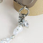 Star-shaped metal and pearl embellished phone strap with mixed metallic bead detailing