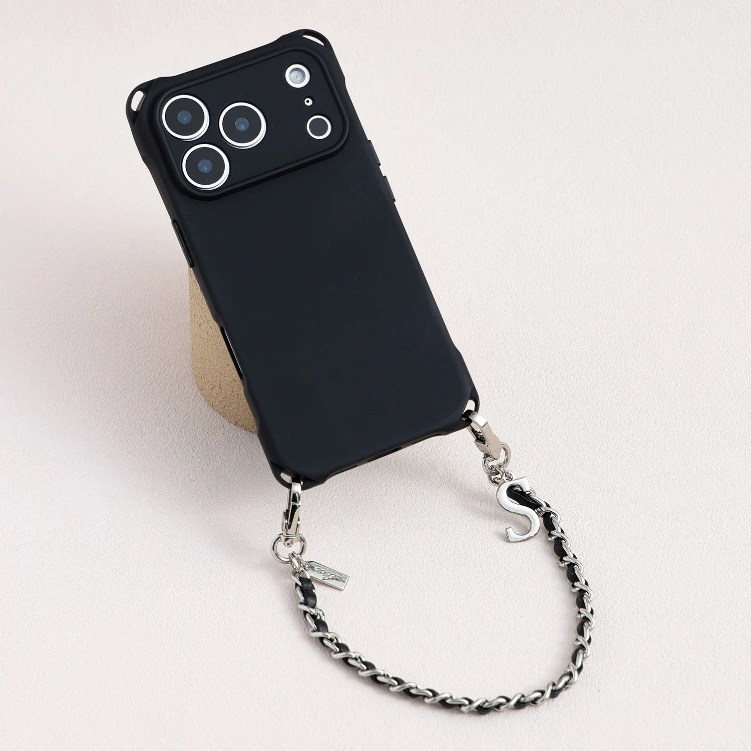 Minimal sculpted TPU phone case paired with detachable metal and split leather chain
