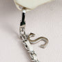 Close-up of detachable clasp and leather-woven chain connection on sculpted phone case