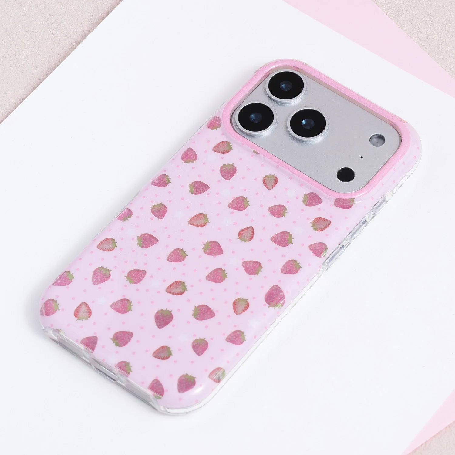 Full view of a pink strawberry TPU phone case with miniature fruit motif, slim profile, and softly romantic vintage-inspired finish.