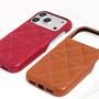 Close-up of a scarlet red phone case and caramel tan case highlighting the textured grain and stitched geometric pattern.
