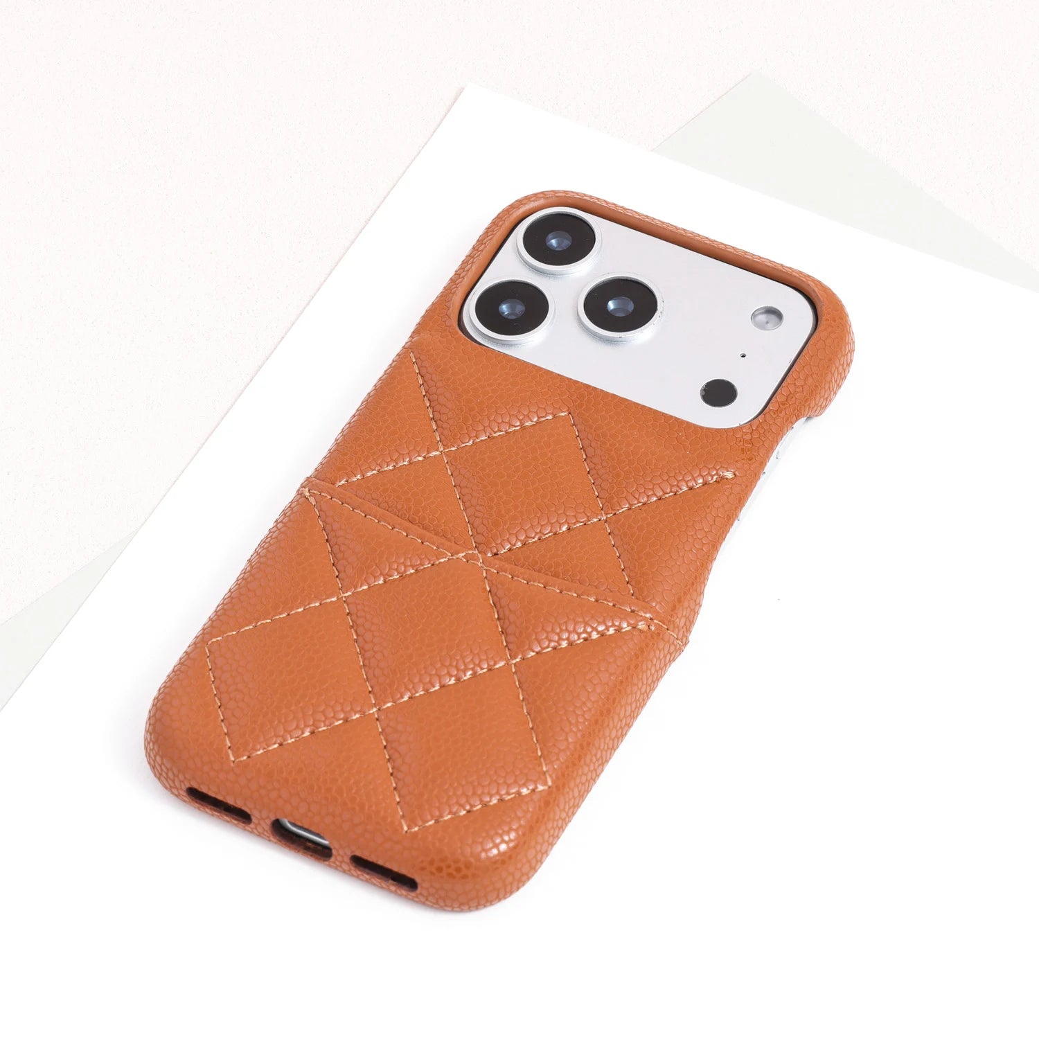 Single caramel tan quilted leather phone case with geometric stitched detailing.