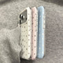 Angled side profile of pastel star phone cases in white, pink, and blue with transparent sides