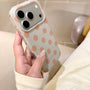 Angled close-up of a soft mint green polka dot phone case with warm beige dots, showing the smooth finish and side profile.