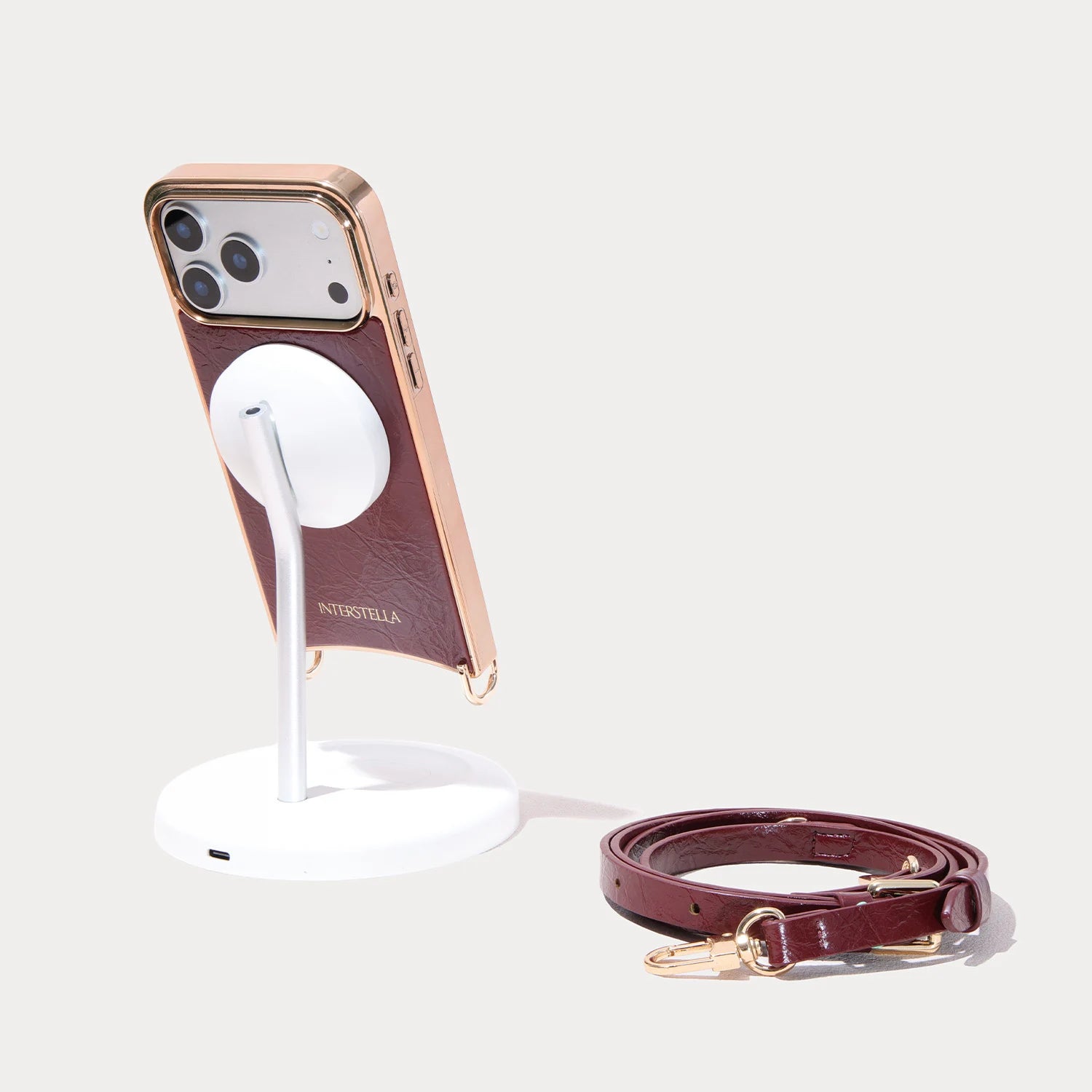 MagSafe-compatible Asteria Portico iPhone case shown on magnetic charging stand