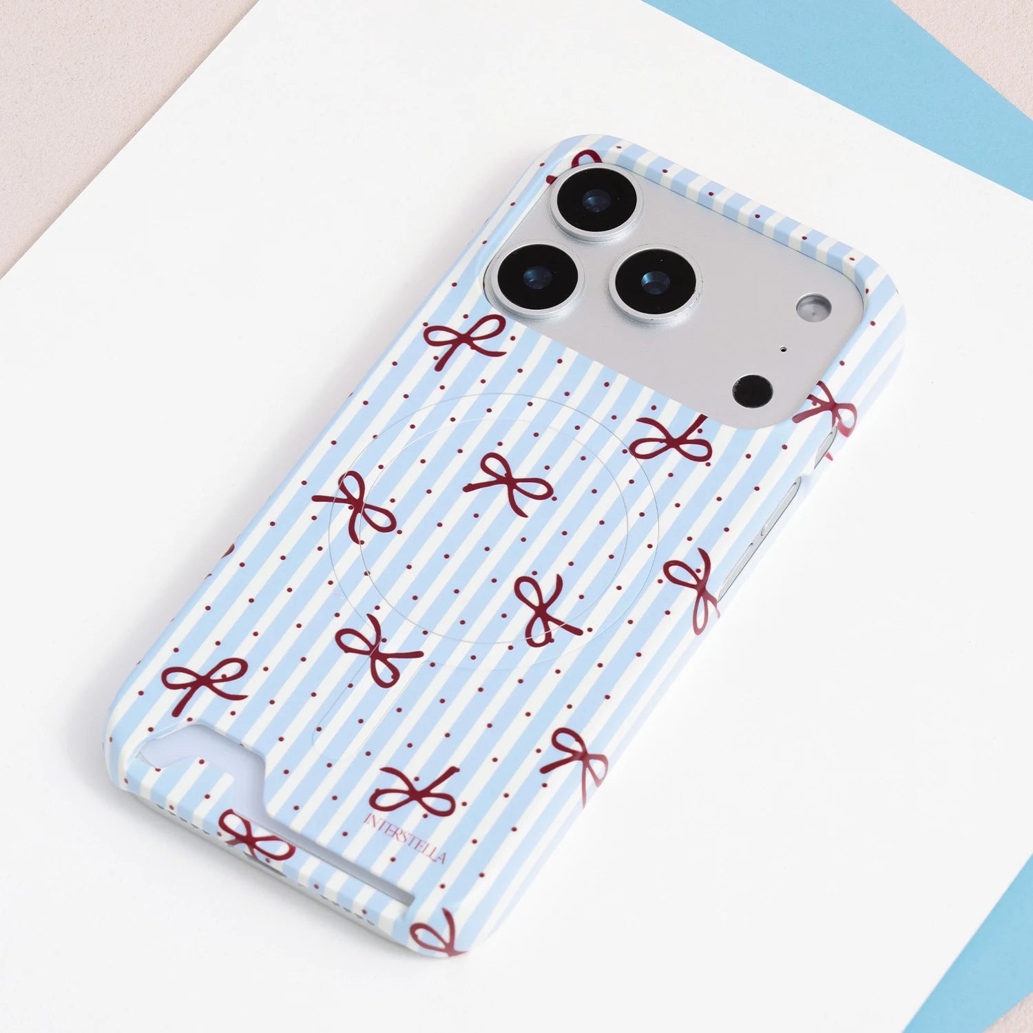 Light blue striped card phone case with crimson ribbon bows, dotted detailing, and built-in card slot in slim PC material.