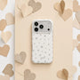 White matte star phone case with silver star print on a beige heart backdrop