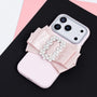 Blush pink phone case featuring a handmade oversized satin bow with a crystal buckle centerpiece and raised camera surround.