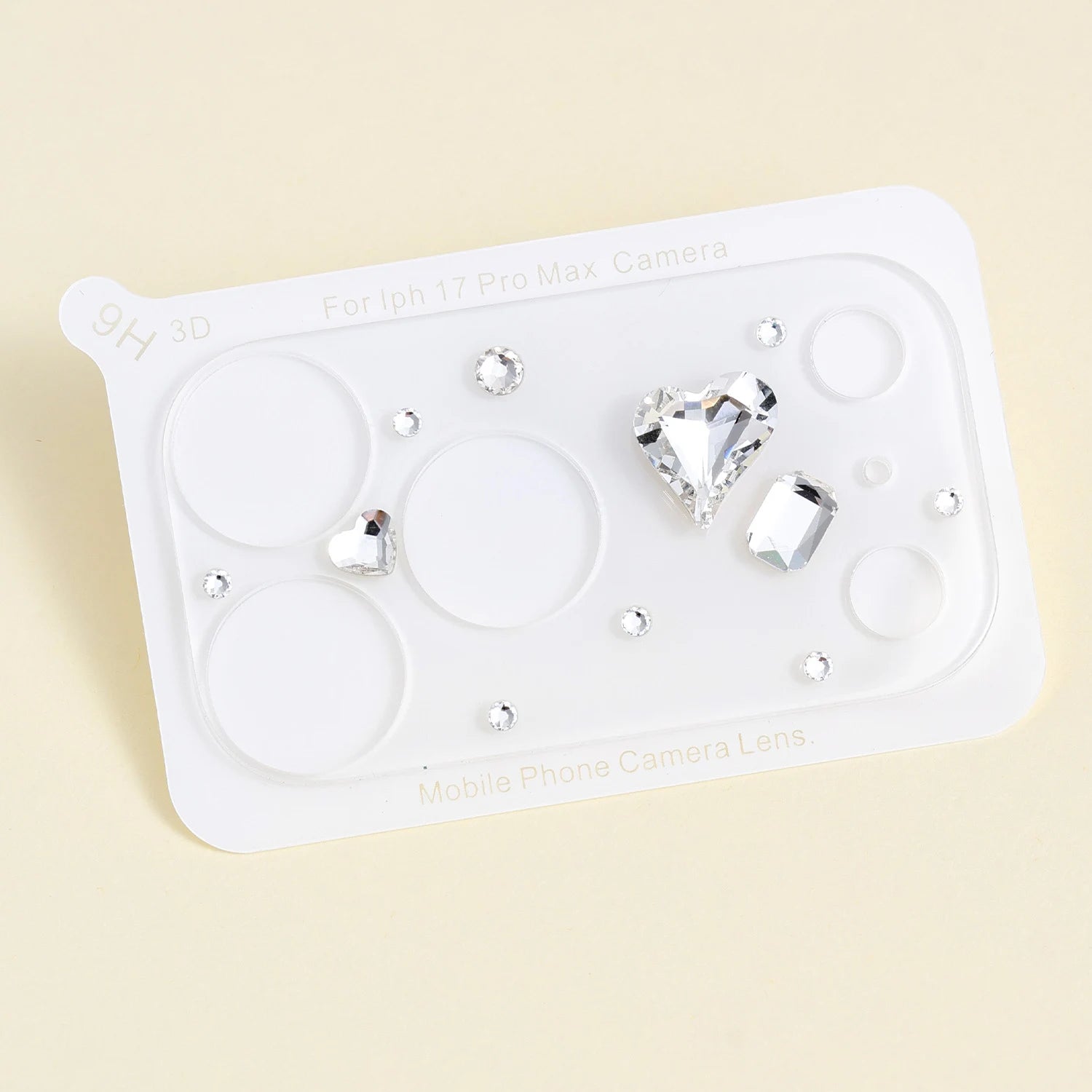 Clear acrylic camera lens protector sheet featuring a large heart-shaped crystal, a faceted rectangular stone, and small silver rhinestone accents.