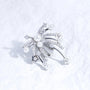 Pearl and crystal starfall ear charm with silver-tone plated finish on a white textured surface