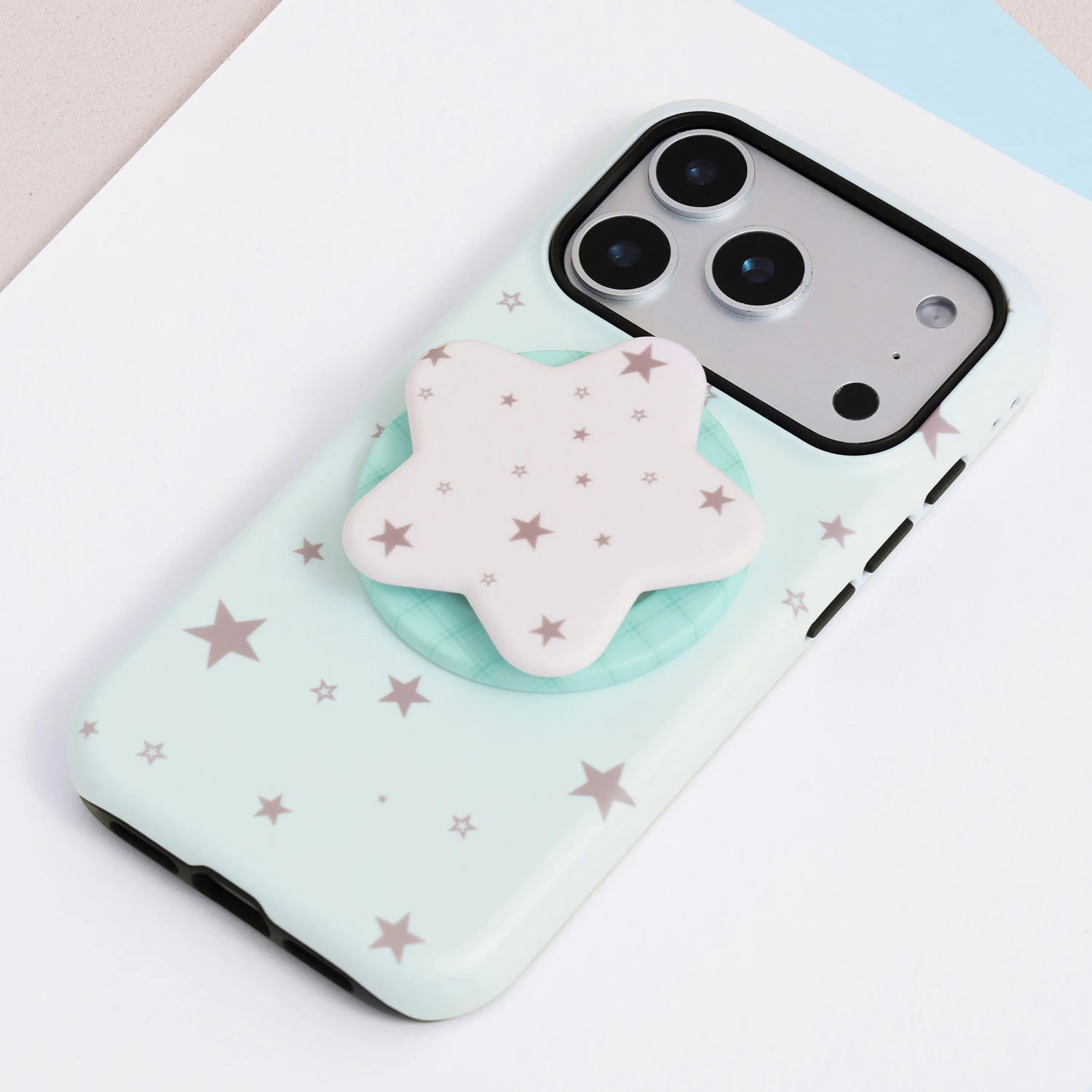 Mint celestial phone case without grip, showing scattered star motifs, dual-layer structure, and raised camera protection.