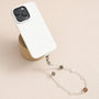 Grey moonstone, white quartz and peach moonstone gemstone phone strap with custom metal link clasp, handmade detachable bracelet phone strap on a neutral background.