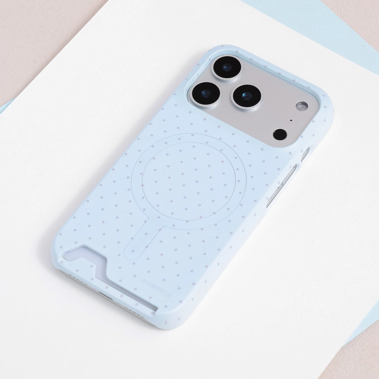 Full view of the powder blue polka dot card phone case with slim PC construction and circular back detail.