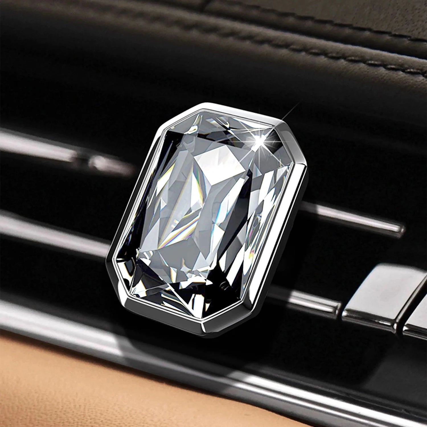 Luxury rectangular crystal car diffuser clipped onto a black car air vent with brilliant prism reflections