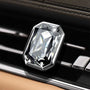Luxury rectangular crystal car diffuser clipped onto a black car air vent with brilliant prism reflections