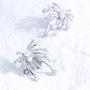 Pearl and crystal starfall ear charm with silver-tone plated finish on a white textured surface