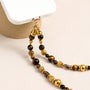 Tiger’s eye gemstone phone strap with gold metal accents, detachable bracelet design