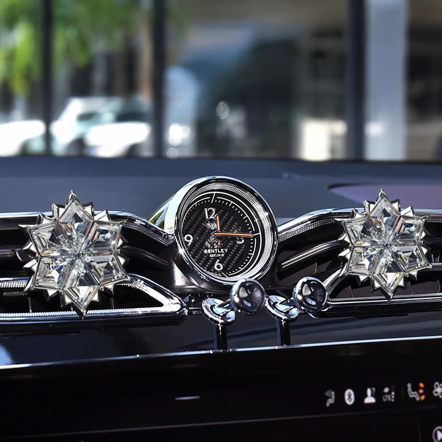 Luxury crystal car diffuser displayed on a beige stone pedestal