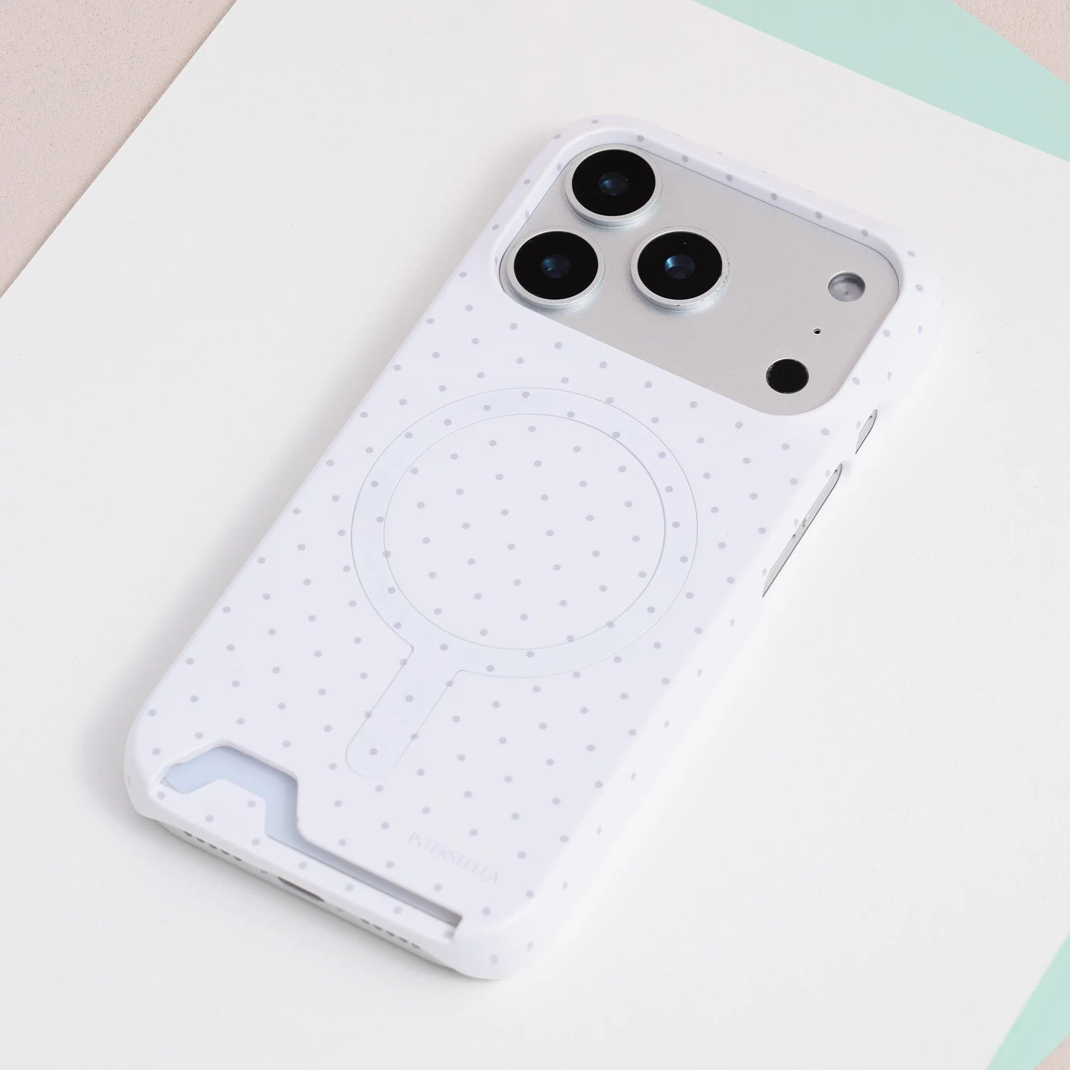 Full view of the porcelain white polka dot card phone case with delicate dotted pattern and integrated card slot.