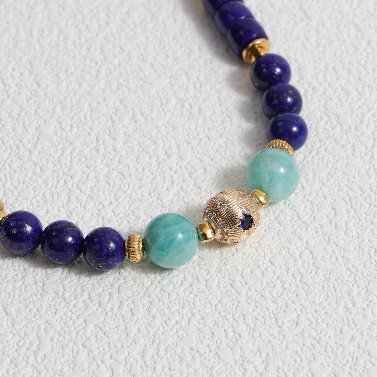 Lapis Lazuli and Amazonite gemstone phone strap with gold metal details, detachable bracelet design
