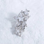 Silver-tone starburst crystal ear charm with clear stones on a white textured background