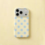 Butter yellow polka dot phone case with powder blue dots and raised camera surround on a pale yellow background.