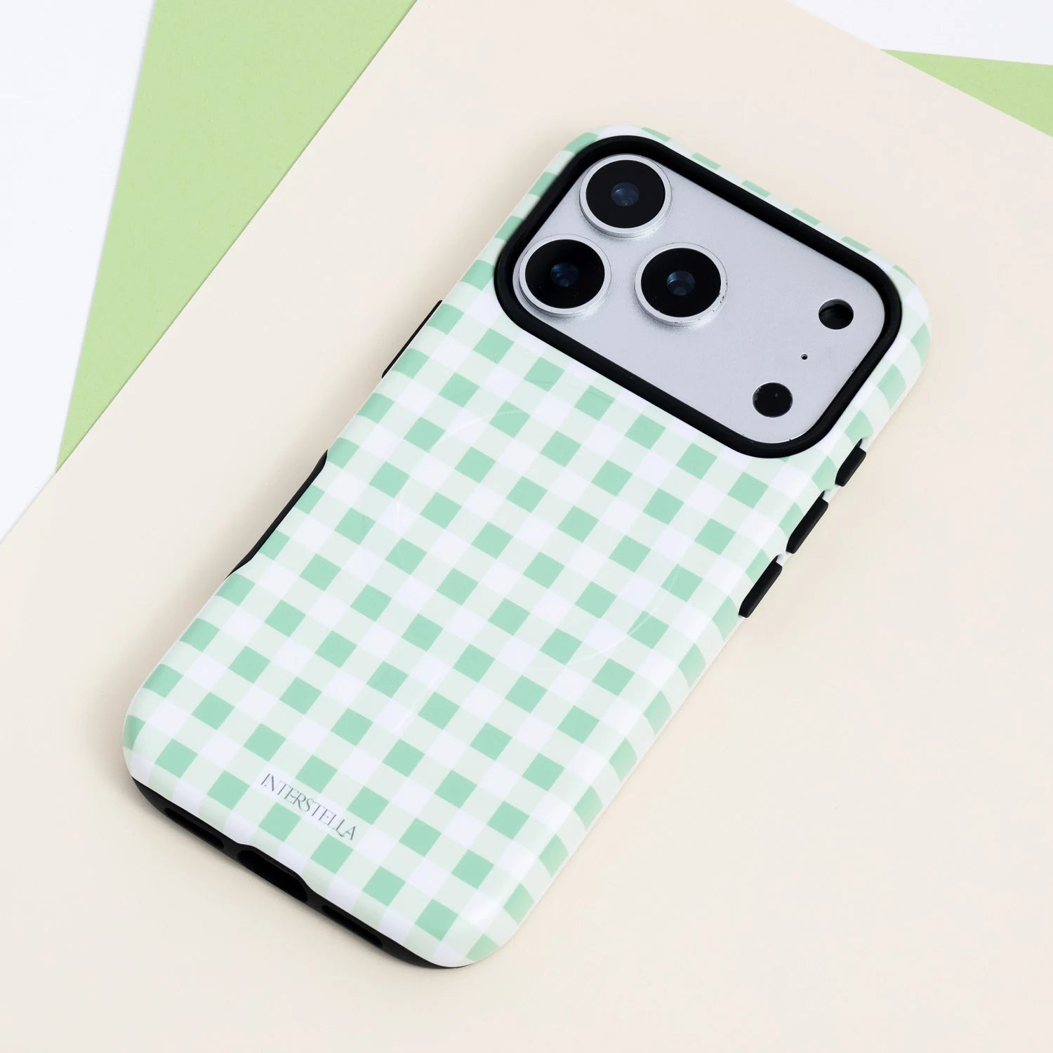 Mint gingham dual-layer phone case with a pastel green and white check pattern, black side buttons, and raised black camera frame.