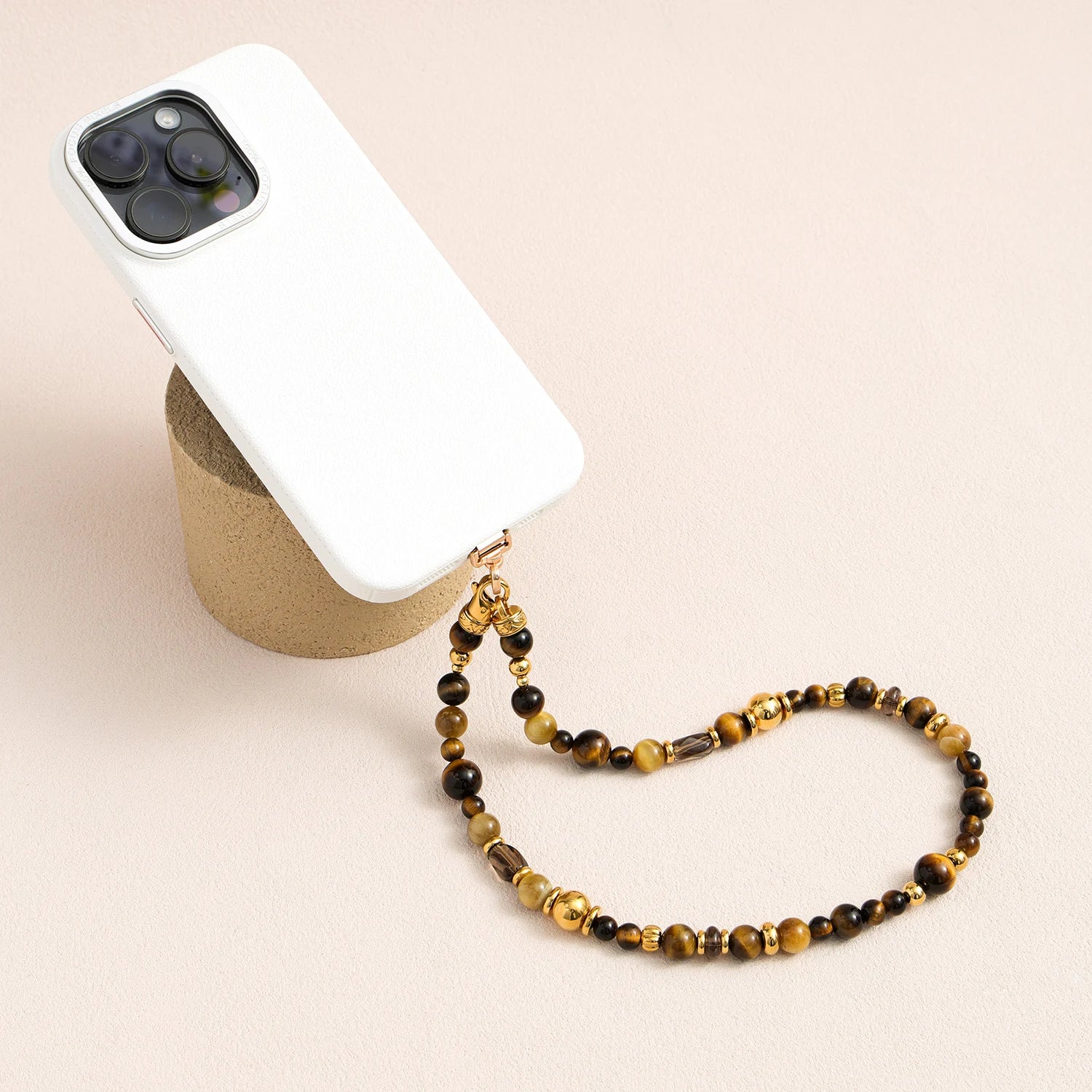 Tiger’s eye gemstone phone strap with gold metal accents, detachable bracelet design