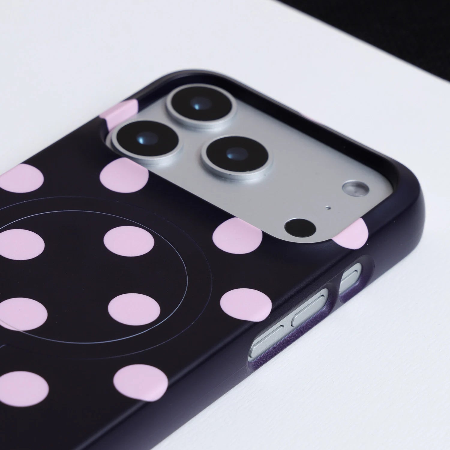 Close-up of Interstella polka dot phone case showing raised camera surround and side button cutouts
