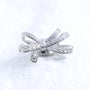 Crystal butterfly ribbon ear charm with Swarovski detailing and silver-tone finish on a white textured surface