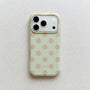Soft mint green polka dot phone case with warm beige dots and raised camera surround on a light neutral background.