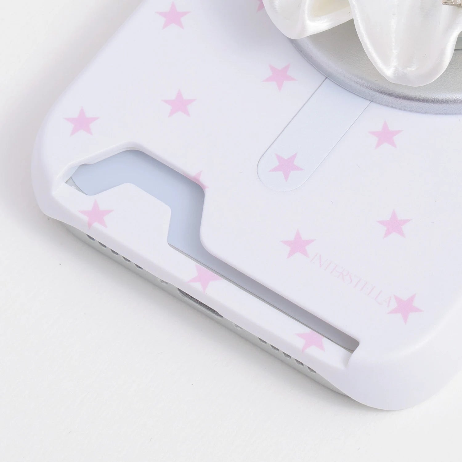 Close-up of the white star print card phone case bottom section showing the card slot opening and blush-pink stars.