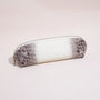 Close-up of the croc-embossed leather texture and silver-tone zipper on a slim pencil case