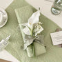 Sauge Orchidée floral gift wrapping style with orchid embellishment, ribbon accent, and soft botanical textured wrap