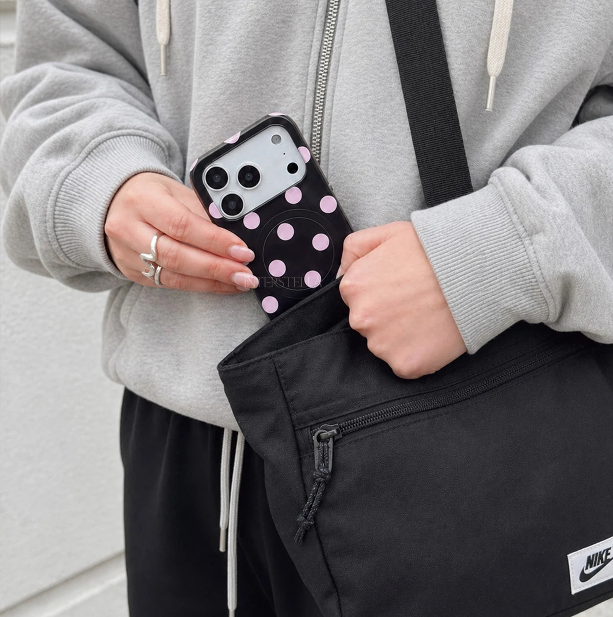 Front view of Interstella polka dot hard-shell phone case with back card holder design