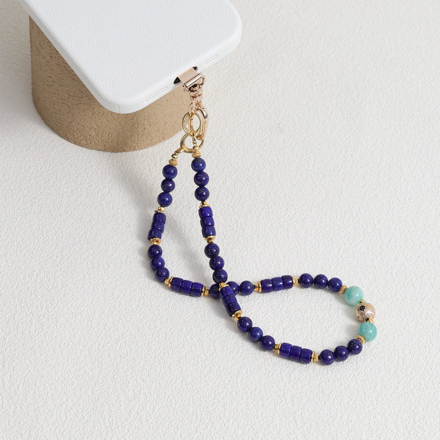 Lapis Lazuli and Amazonite gemstone phone strap with gold metal details, detachable bracelet design