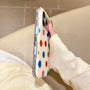 Side view of an ivory dot phone case with clear edges and covered buttons