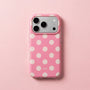 Candy pink polka dot phone case with ivory dots and raised camera surround on a pastel pink background.