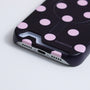 Close-up of Interstella polka dot hard-shell phone case showing bottom card slot opening and logo detail
