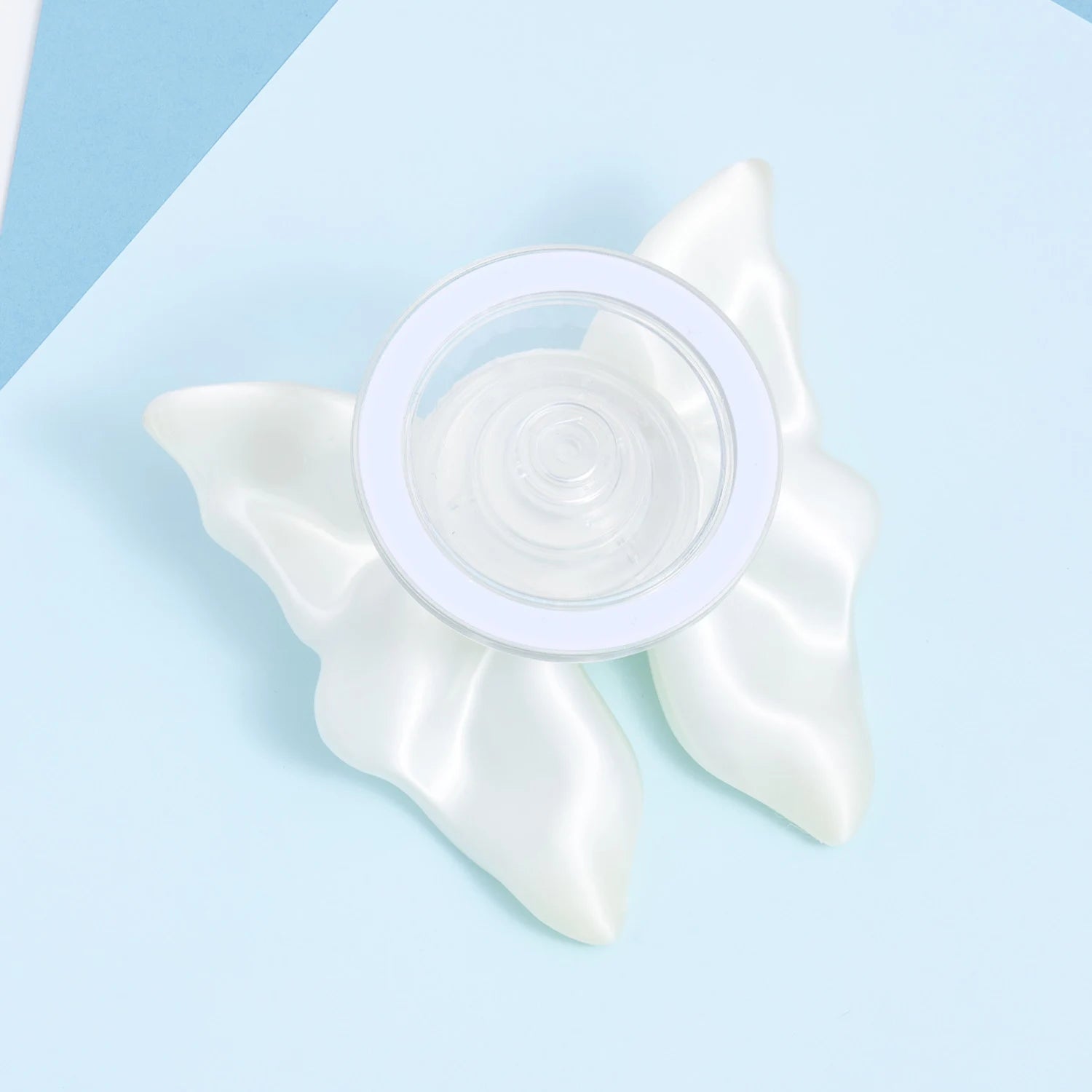 Back view of the 3D-printed bow phone stand showing the circular support base attached behind the sculptural white bow form.