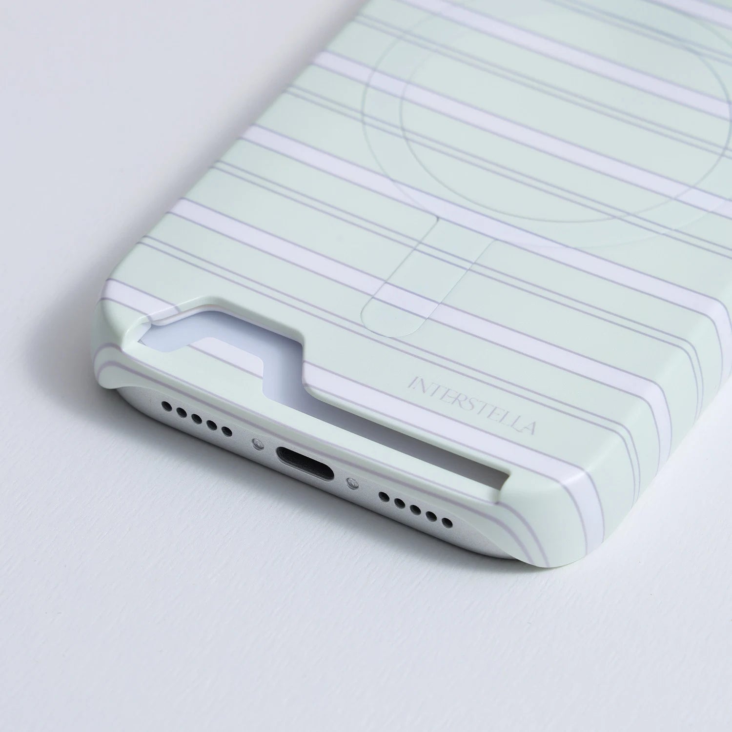 Close-up of mint striped card slot phone case showing bottom card opening and charging port cutout
