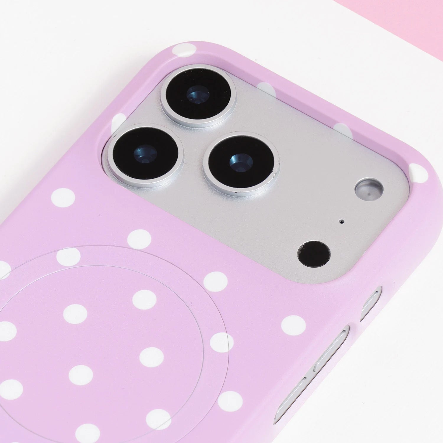 Close-up of the blush pink polka dot card phone case camera section with ivory-white dots and clean structured edges.